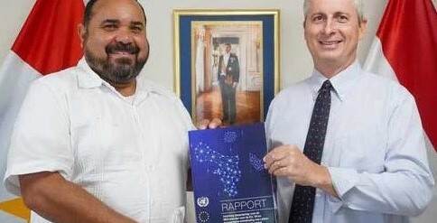 Special Envoy Edison Rijna presenting a report to Saba Island Governor Jonathan Johnson.